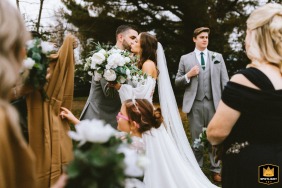 At the Briar Patch Bed & Breakfast in Middleburg, Virginia, a WPJA wedding photographer captures a poignant moment as a groom tenderly kisses his new bride's face following their emotional ceremony.